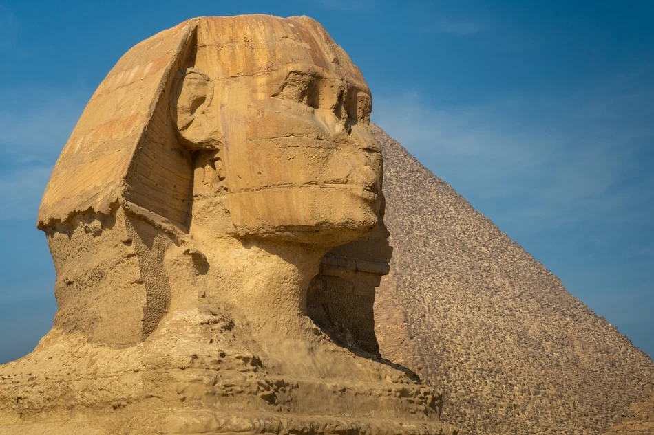 The Great Sphinx with the Giza Pyramid in the background, Cairo Egypt.